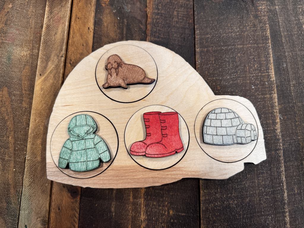 Completed Igloo Peekaboo Puzzle showcasing vibrant letters and matching symbols like a walrus, coat, boots, and an igloo, perfect for pre-K and preschool activities.