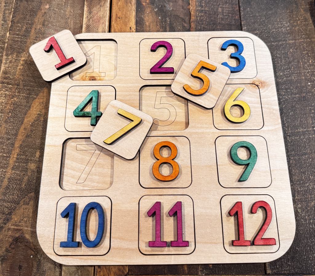 Handcrafted Leveled Learning Number Puzzle Board, ideal for Pre K, preschool, daycare, and homeschool. Supports pre mathematics, number counting, and fine motor skills. Features vibrant, color-coded numbers for counting 1-10, shape recognition, and sequencing. Includes a built-in storage board for organized learning fun