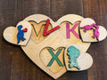 Multi-layered heart puzzle showing brightly colored wooden pieces with dinosaur companions, designed for early literacy and pre-reading skills in preschool and daycare settings.