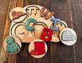 Wooden Igloo Peekaboo Puzzle in progress, with letter pieces removed to reveal matching symbols, encouraging fine motor skills and early literacy development.