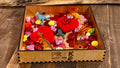  Sensory bin example filled with Valentine's-themed items, encouraging fine motor coordination, sensory exploration, and hands-on learning for preschoolers