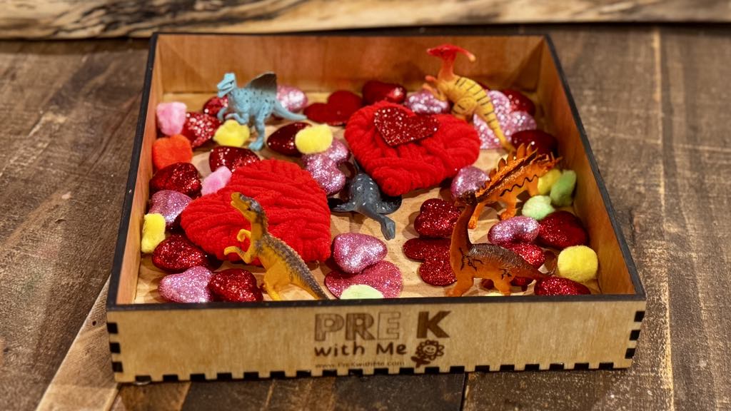  Sensory bin example filled with Valentine's-themed items, encouraging fine motor coordination, sensory exploration, and hands-on learning for preschoolers